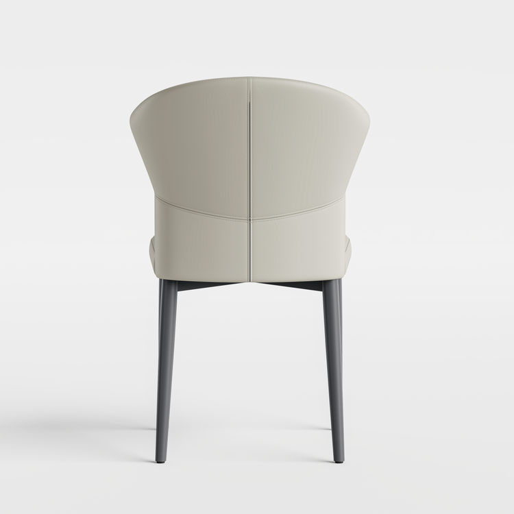 Cream upholstered accent chair with a rounded wraparound back and four dark legs on white