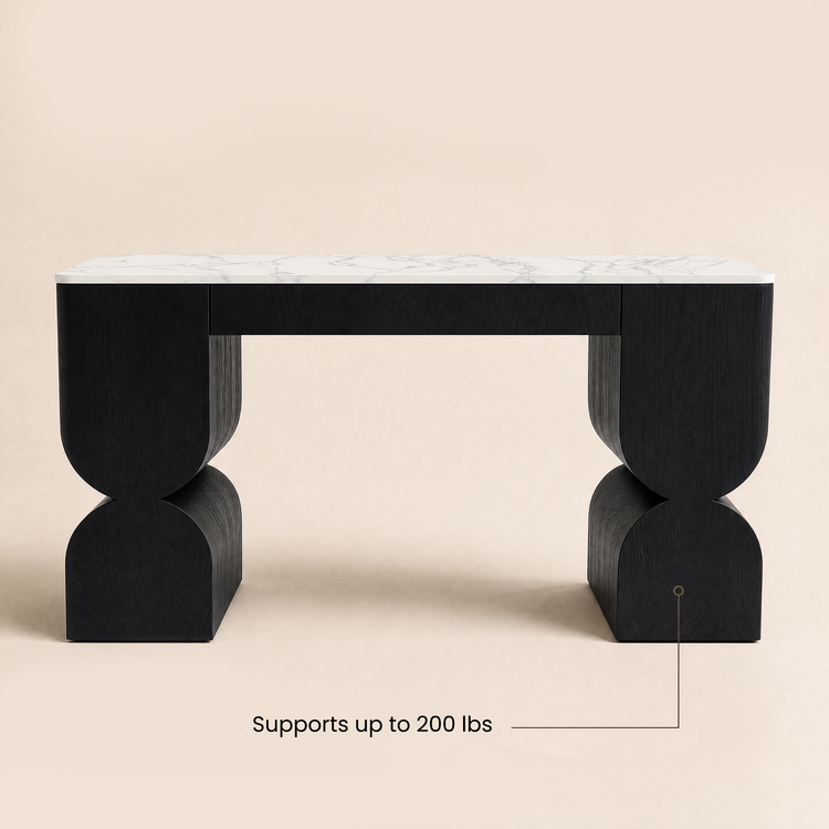 Black sculptural console table with a white marble-patterned top and curved supports.