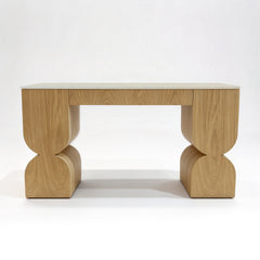 Light wood desk with a pale stone top and sculptural curved legs.