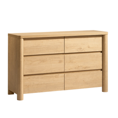 Light wood dresser has six handleless drawers and rounded front posts