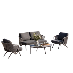 Cutout outdoor set with a sofa, two dark chairs, and a round coffee table on black