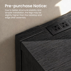Close-up of a dark wood-grain tabletop corner with two electrical outlets; overlaid notice says the legs may sit slightly higher than the tabletop edge after assembly.