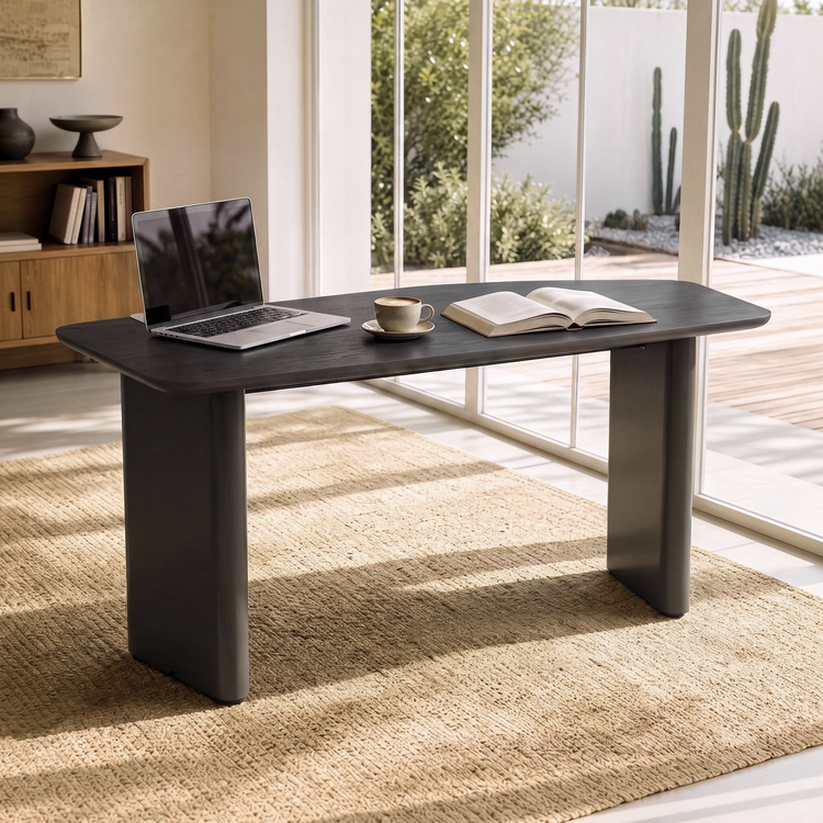 Dark rectangular table with broad panel legs staged with a laptop and books in a bright room