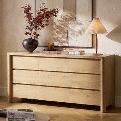 Light wood dresser has nine handleless drawers in three rows