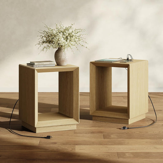 Two wood-tone nightstands with open compartments, tabletop charging ports and power cords on the floor