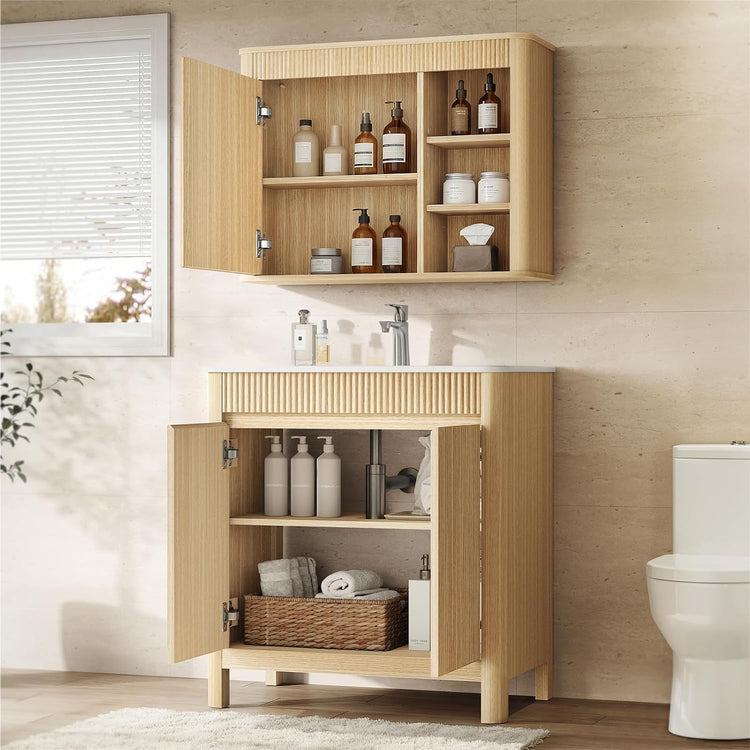 Light wood-tone bathroom vanity and wall cabinet with doors open to reveal shelves holding toiletries and towels