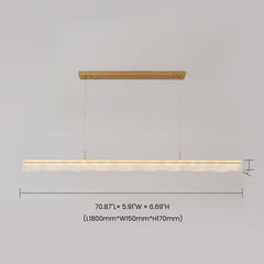 Diagram of a long illuminated pendant light with textured clear panels, a gold-colored rectangular ceiling mount, thin suspension cables and dimension lines.