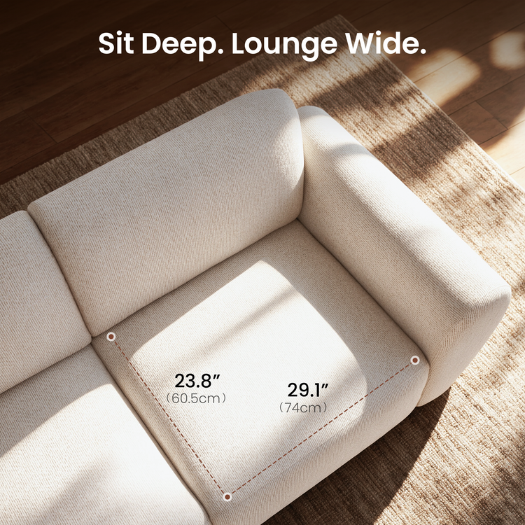 Diagram of a cream-colored sofa seat with dashed lines marking seat depth and width, viewed from above on a tan rug.
