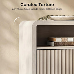 The visible drawer front has vertical fluting and the cabinet frame has a rounded upper corner