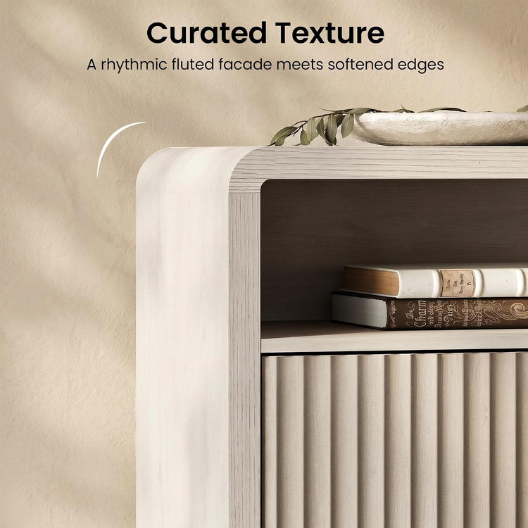 The visible drawer front has vertical fluting and the cabinet frame has a rounded upper corner