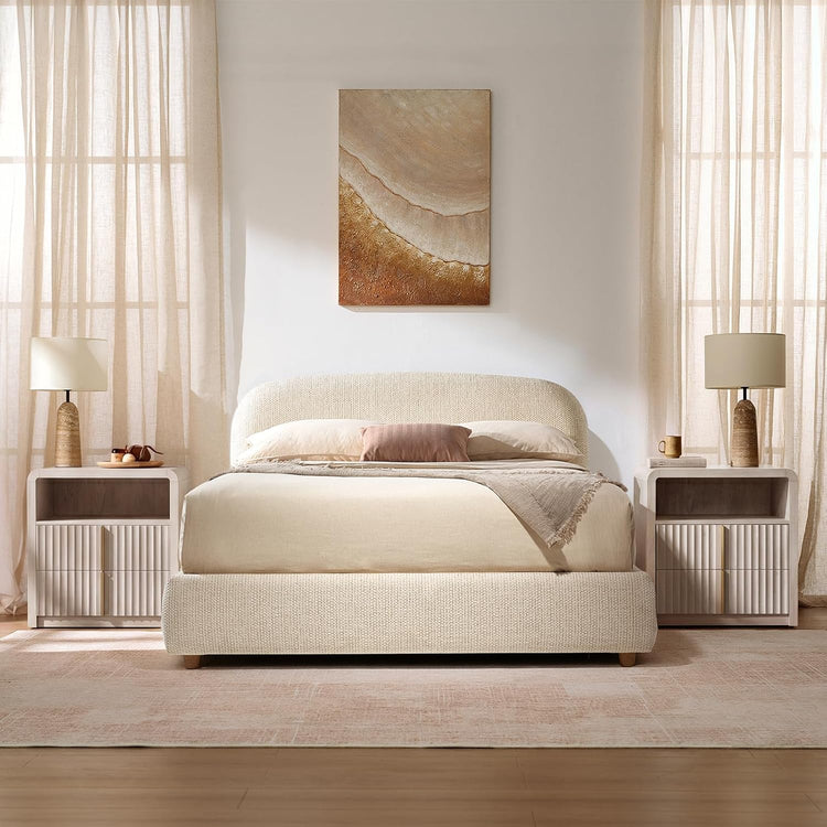 A bed is centered between two matching nightstands beneath a wall artwork
