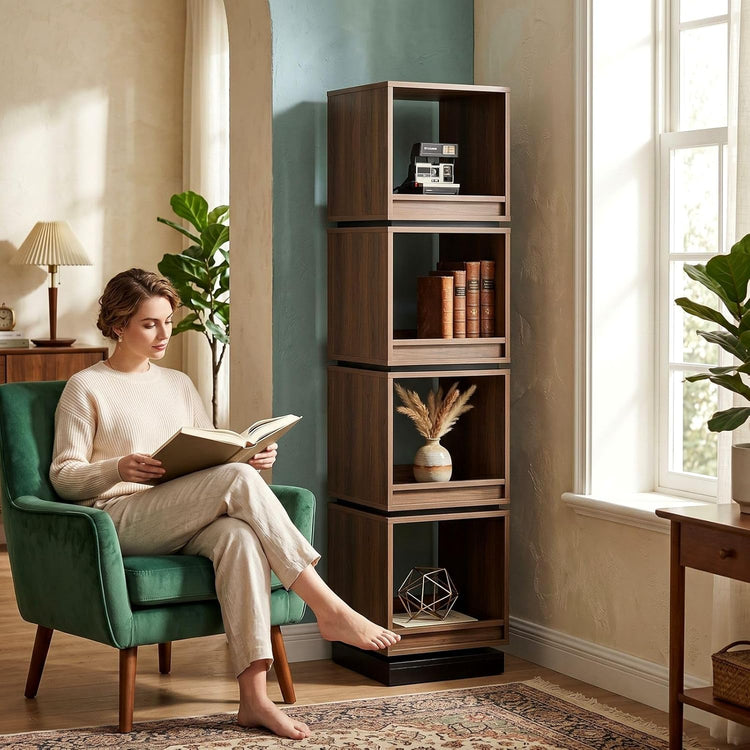 Dark wood-tone four-tier bookshelf tower holding books and ornaments beside a seated reader