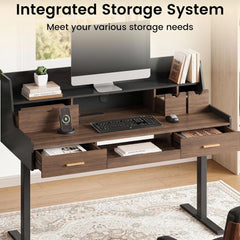 A computer desk has a raised monitor shelf, open storage cubbies, and three drawers, with a monitor, keyboard, mouse, books, and a phone on its surfaces.