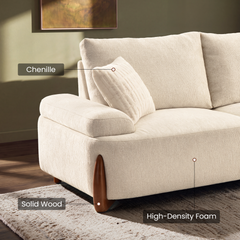 Close-up of a cream sofa with labels identifying chenille upholstery, solid wood feet, and high-density foam.