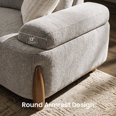 Close-up of a beige upholstered chair armrest with a rounded wooden support; an overlay marks the armrest as 13 inches (33 cm) wide.