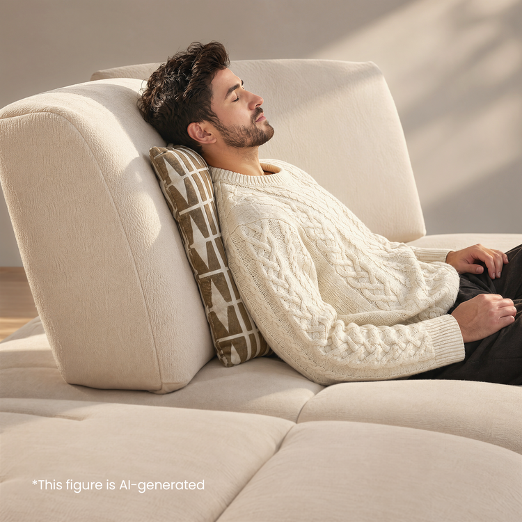 Man resting with eyes closed on a cream sectional sofa.