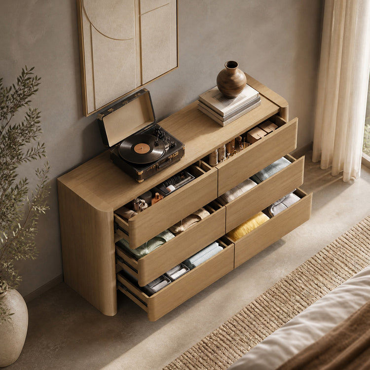 Dresser shown with open drawers in a furnished room