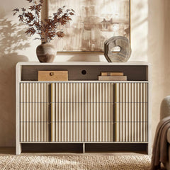 Dark wood sideboard with three ribbed front doors, slim gold pulls, and decor on top
