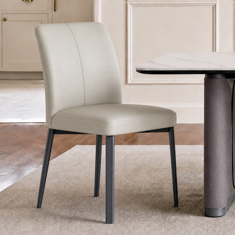 Cream upholstered dining chair beside a round table