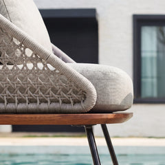 The chair side combines a wrapped outer rail with an open woven lattice panel