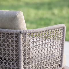Close-up shows gray woven lattice around a chair frame, Gray seat and back cushions are visible