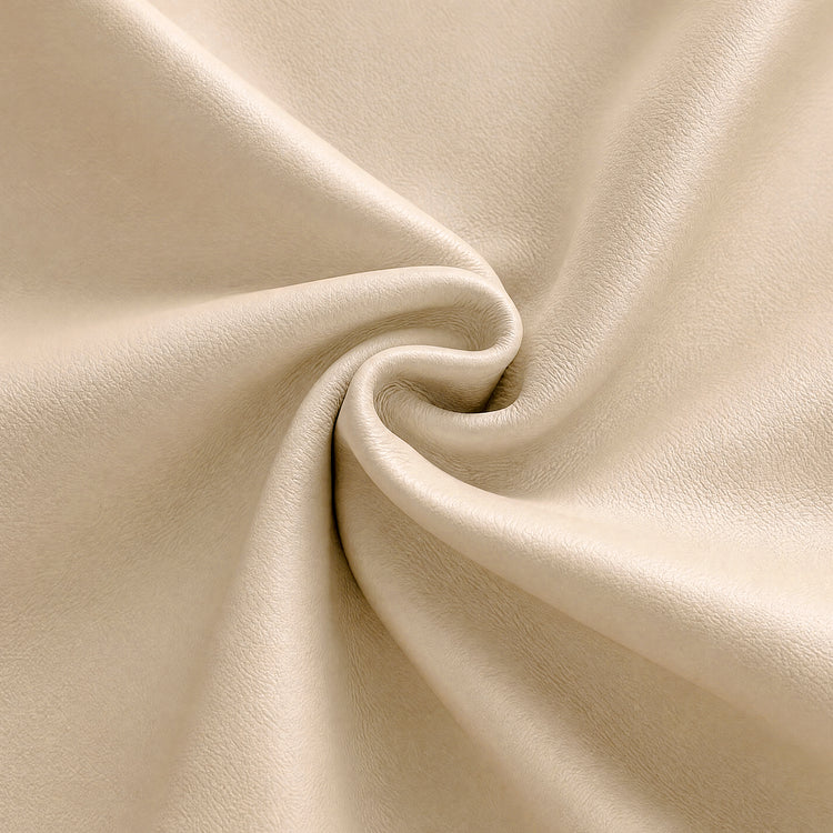 Close-up of a cream-colored, finely textured surface gathered into curved folds around a central swirl.