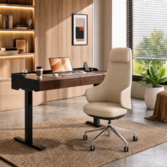 A beige swivel office chair sits at a wood-and-black desk with a laptop, in a bright home office with shelves and a large window.