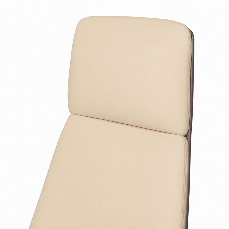Close-up of a cream-colored padded chair back with two sections, rounded corners, stitched edges, and a dark brown frame visible along the right side.