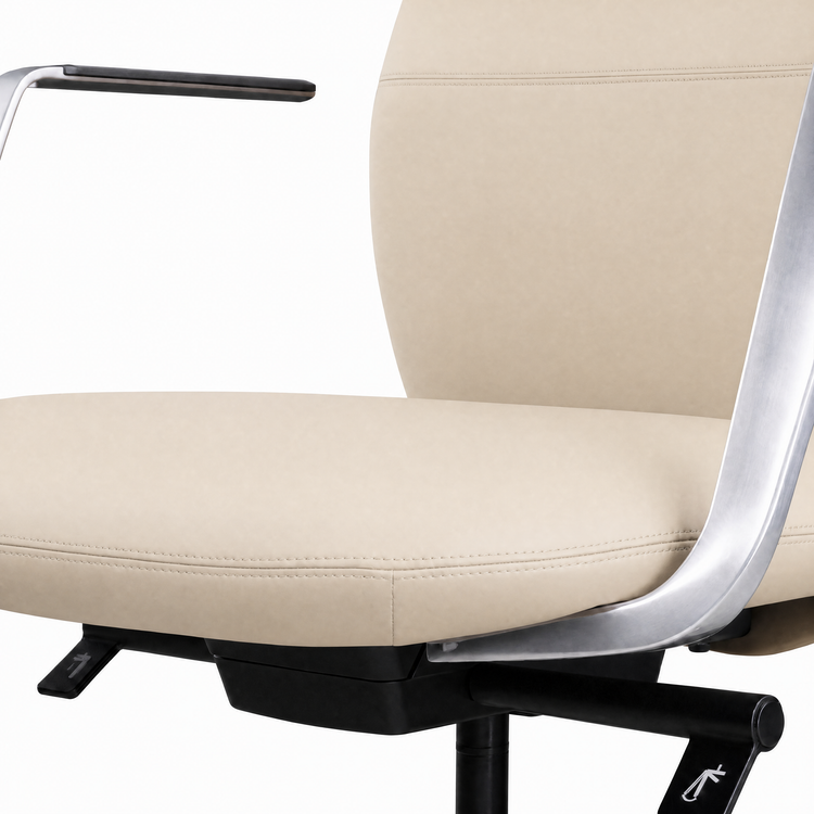 Close-up of a cream-colored chair with stitched seat and backrest, curved silver-colored arm supports, a black arm pad, and black adjustment levers beneath the seat.