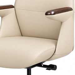 Close-up of a cream-colored chair with stitched upholstery, brown wood-grain armrest tops, and black adjustment controls beneath the seat.