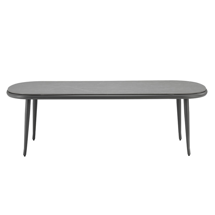 Dark elongated table has a rounded rectangular top and four slender legs