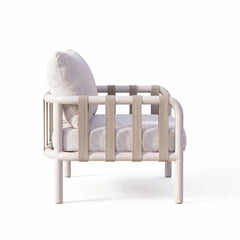 Rear view of a plush white accent chair enclosed by a pale rounded rail frame on white
