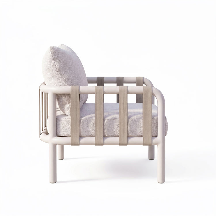 Rear view of a plush white accent chair enclosed by a pale rounded rail frame on white