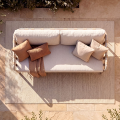 The seating is shown from overhead, Pillows and a throw rest on the seat
