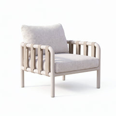 Pale cushioned armchair has a tubular frame and vertical strap loops along both sides