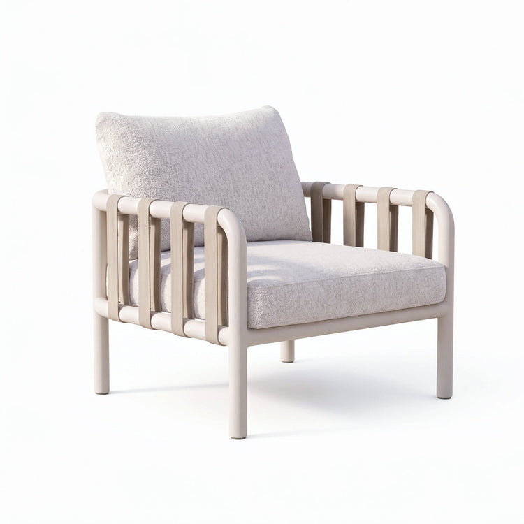 Pale cushioned armchair has a tubular frame and vertical strap loops along both sides