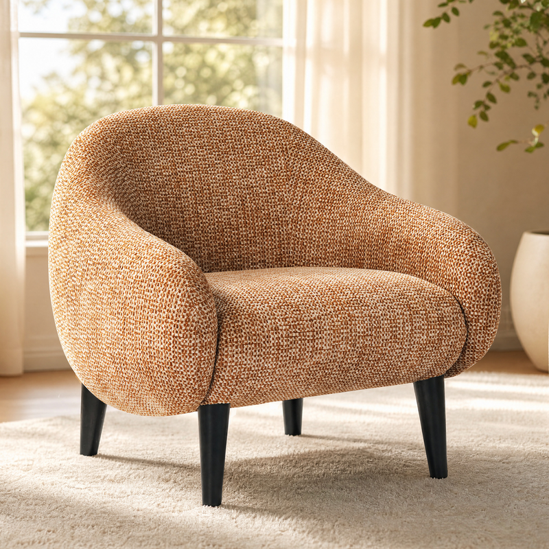 Brown textured barrel chair with rounded wraparound arms and black tapered legs beside a bright window
