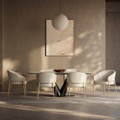 White dining chairs with gold-tone legs surround a table in a sunlit room.