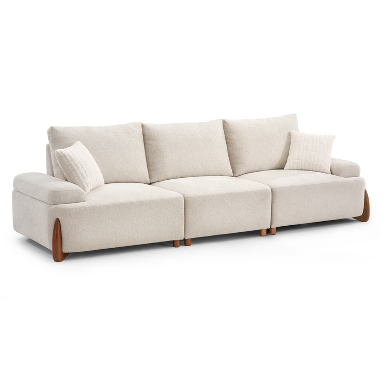 A cream-colored sectional sofa with three seat cushions, three back cushions, two throw pillows, and brown feet against a white background.