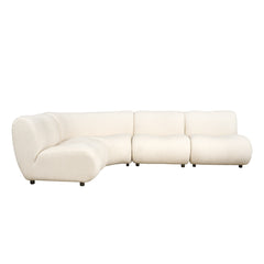 Cream sectional has a curved left chaise, three back cushions, rounded seats, and short dark legs