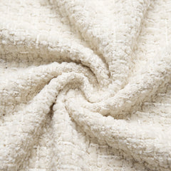 Close-up of a thick looped textile gathered into overlapping folds