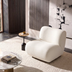 Cream lounge chair shown in a furnished room
