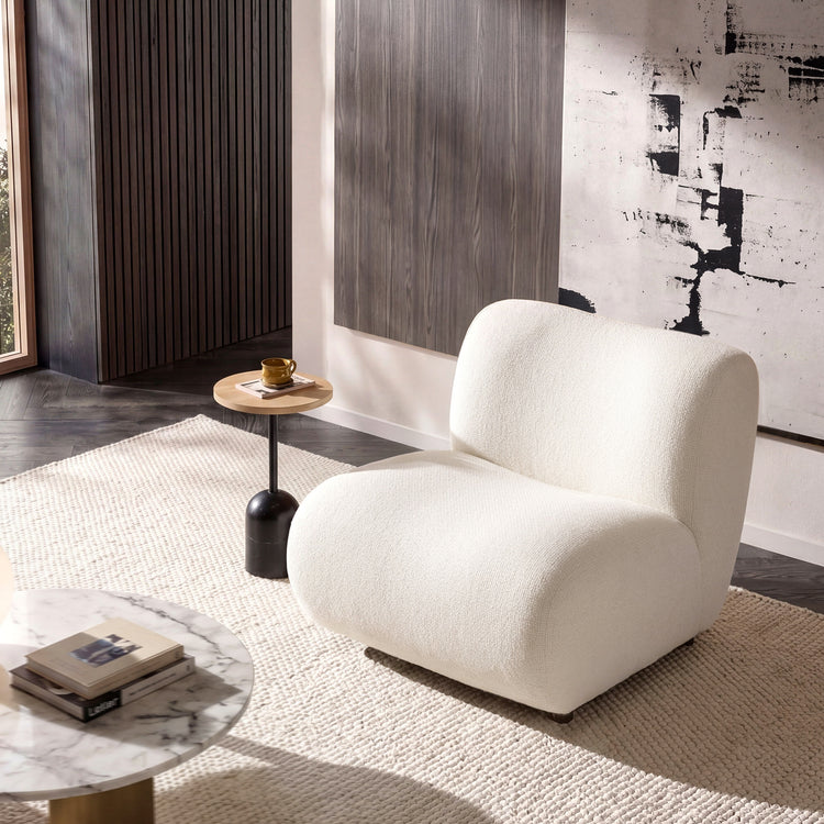 Cream lounge chair shown in a furnished room