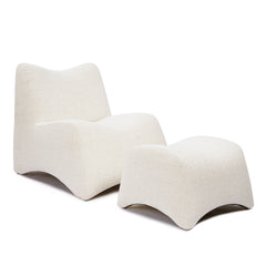 The cream lounge chair has a continuous curved profile and is shown with a matching curved footstool