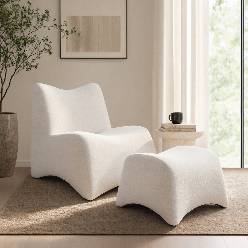 White sculptural lounge chair is paired with a matching ottoman