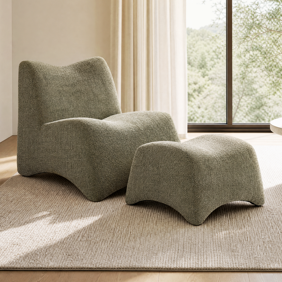 Sculptural upholstered lounge chair and matching footstool have rounded contours and wavy lower edges