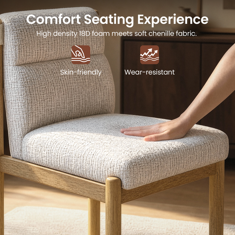A hand presses the light beige textured seat cushion of a chair with a matching padded backrest and a brown frame with visible grain.