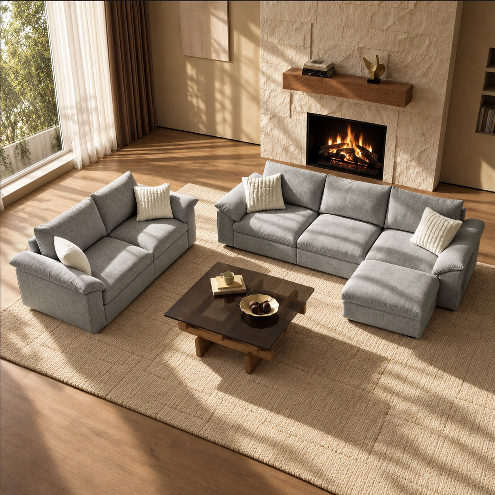 Gray L-shaped sectional and loveseat arranged in a sunlit living room.