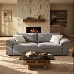 Gray two-seat sofa with wide padded arms in a modern living room.
