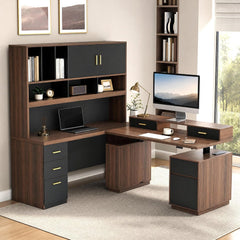 Brown L-shaped desk with black drawer fronts, gold-colored handles, a shelving hutch, and a raised monitor shelf, furnished with a desktop computer, laptop, lamp, books, and plants.